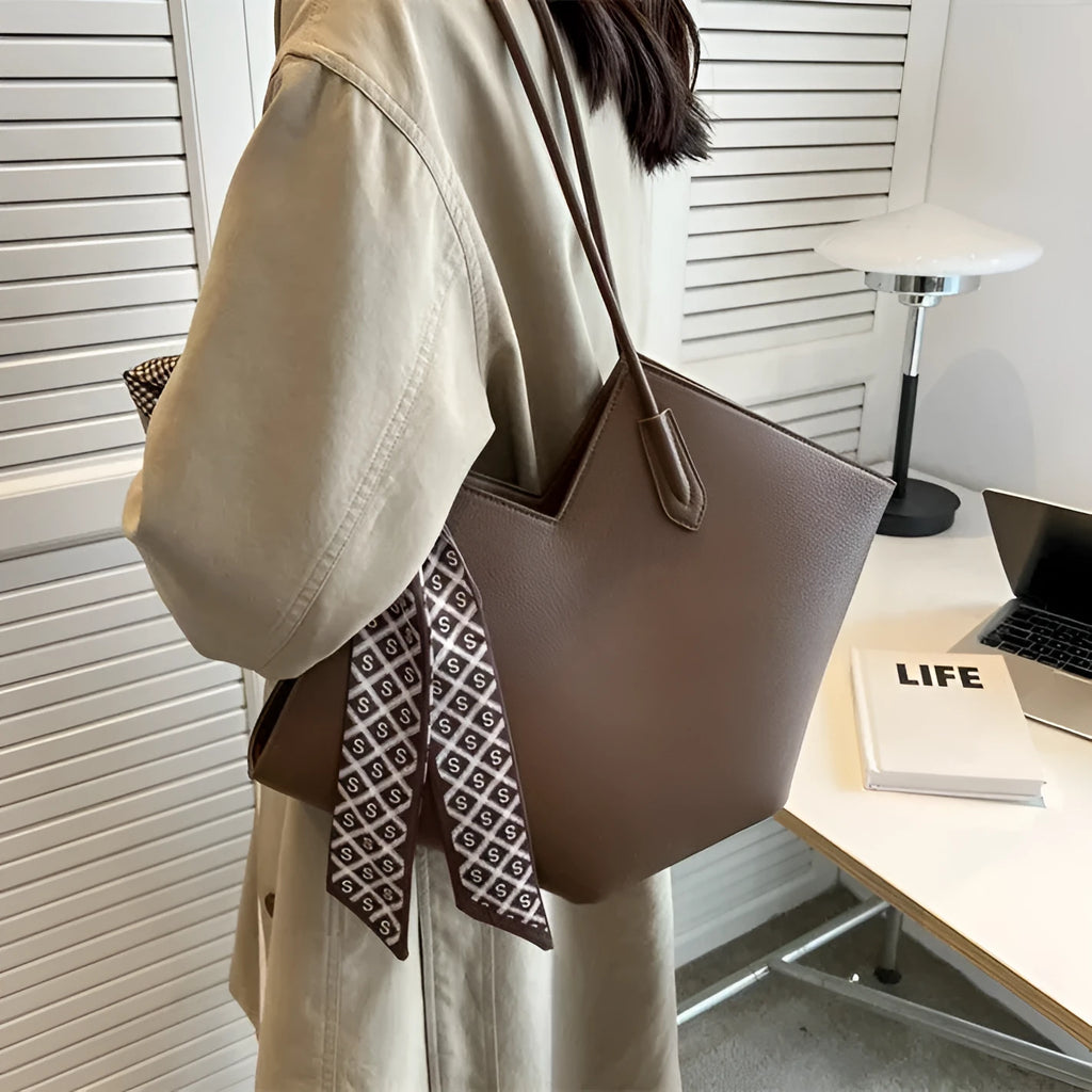 Women's large black PU leather shoulder bag with square shape showing exterior pocket and adjustable handle