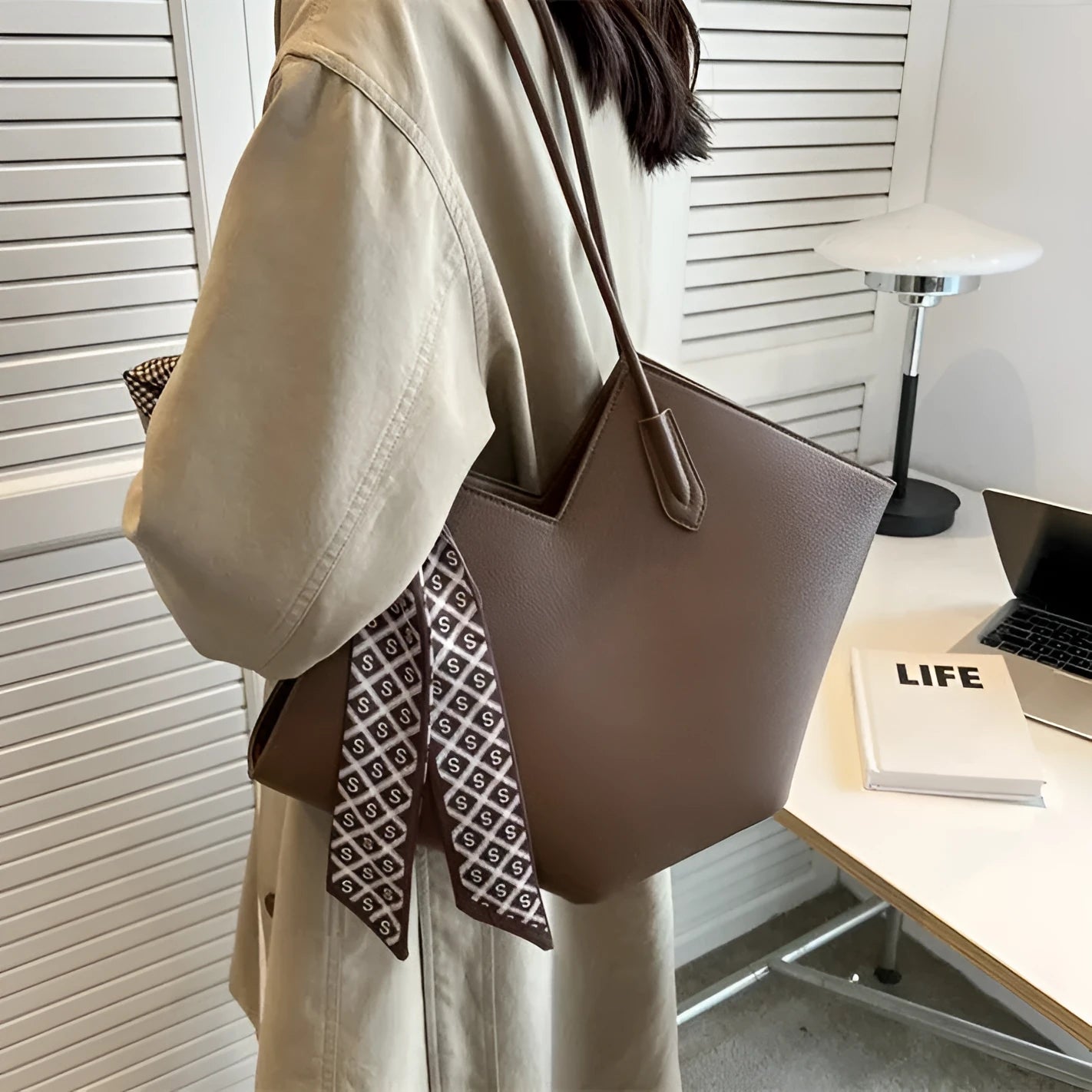 Women's large black PU leather shoulder bag with square shape showing exterior pocket and adjustable handle