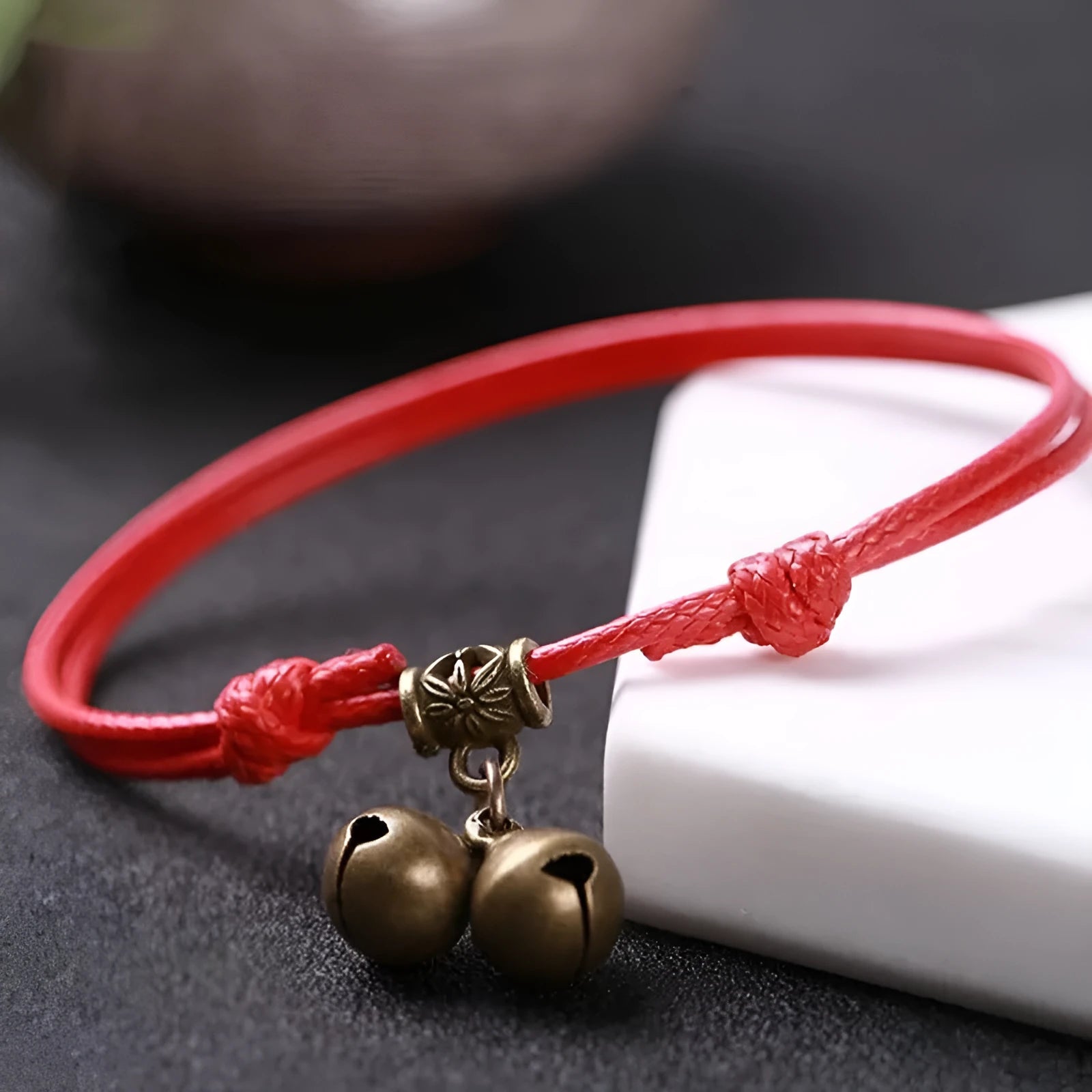 Small dog collar made of nylon rope with a brass bell, shown in black colour.