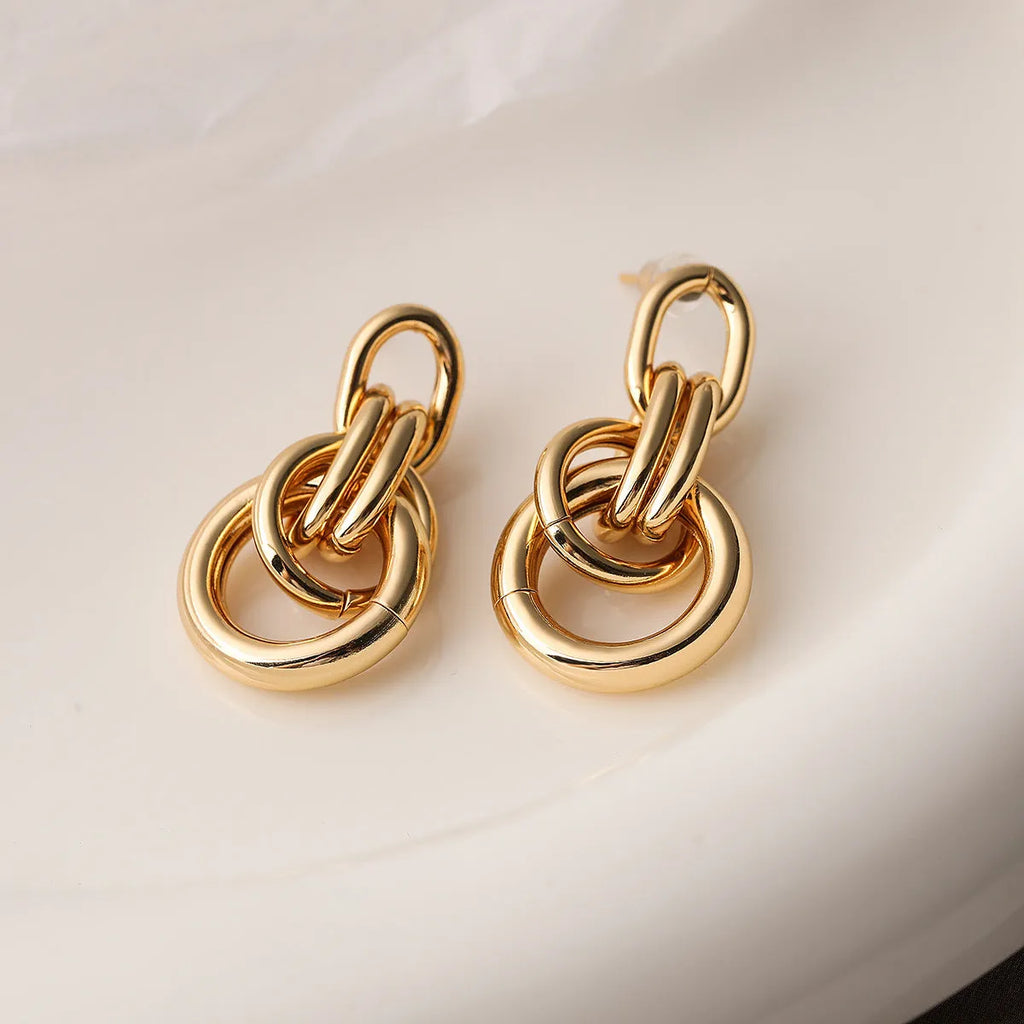 Geometric copper earrings with irregular shape in gold colour options 44093 and 44094