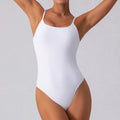 Slim grey sleeveless yoga jumpsuit for women on a model, showing tight fit and one-piece design.