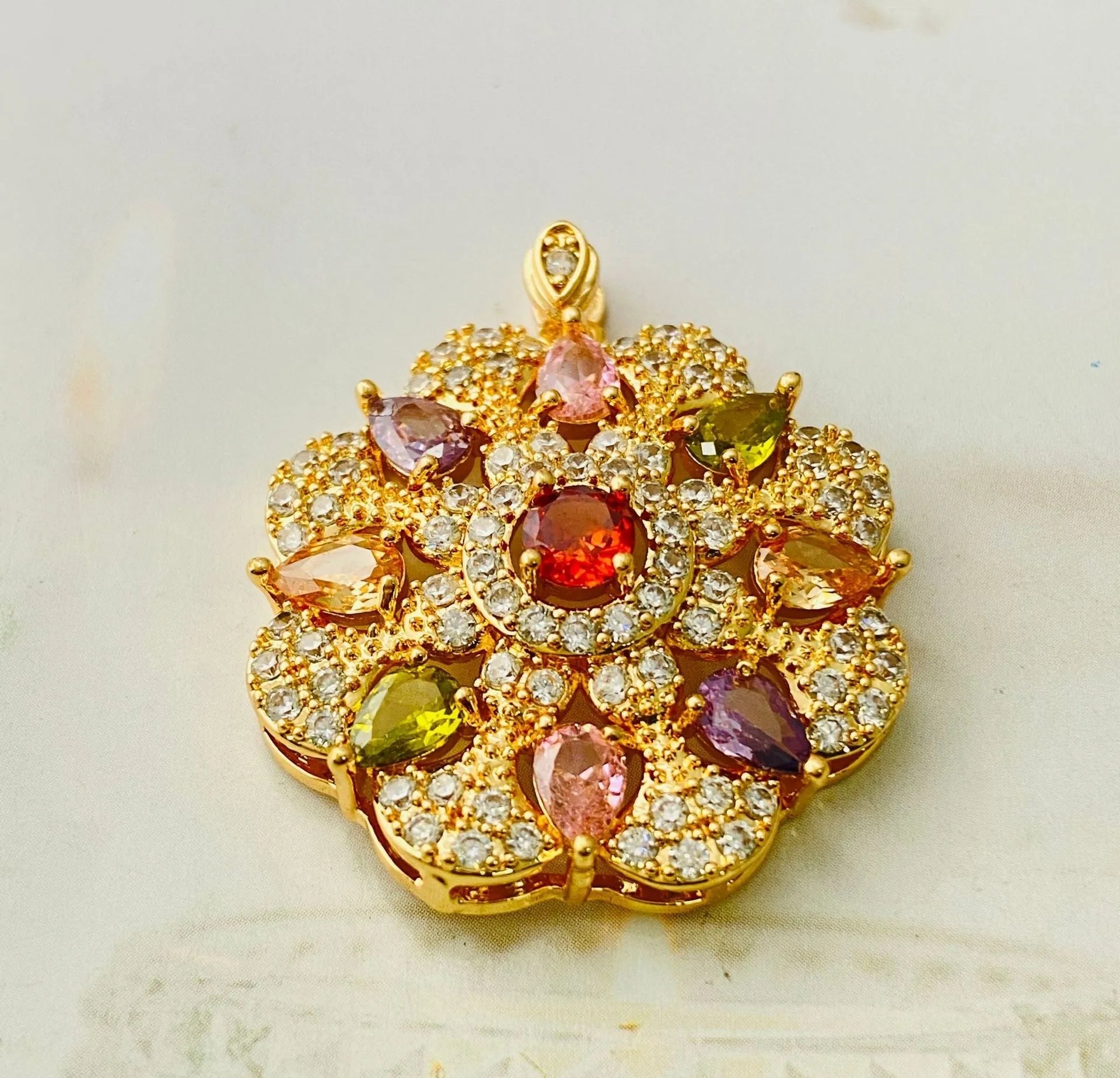 Close-up of a women's floral-shaped zircon pendant necklace in a gold electroplated finish.