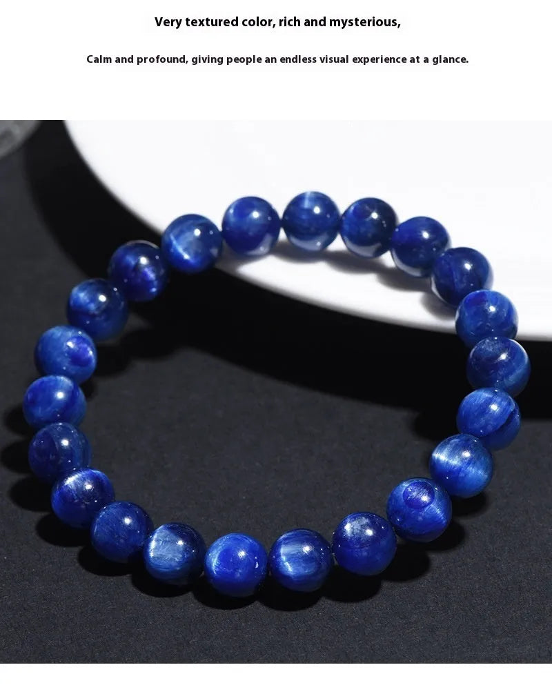 Polished blue crystal ball bracelet with Ruyi charm on a white background.