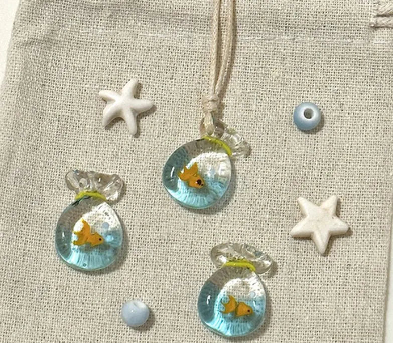 Women's joker design pendant necklace with coloured glaze charm on a cotton and linen clavicle chain.
