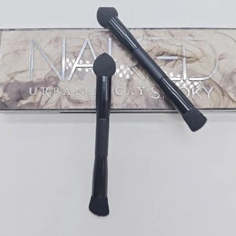 Elegant black double-headed concealer brush with miter sponge and synthetic bristles on a wooden handle.