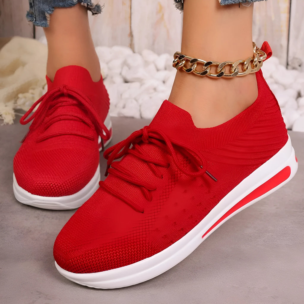 Women's low-top casual sneakers in black, blue, and red with a fly-knit PU upper and front lace-up closure.
