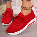 Women's low-top casual sneakers in black, blue, and red with a fly-knit PU upper and front lace-up closure.