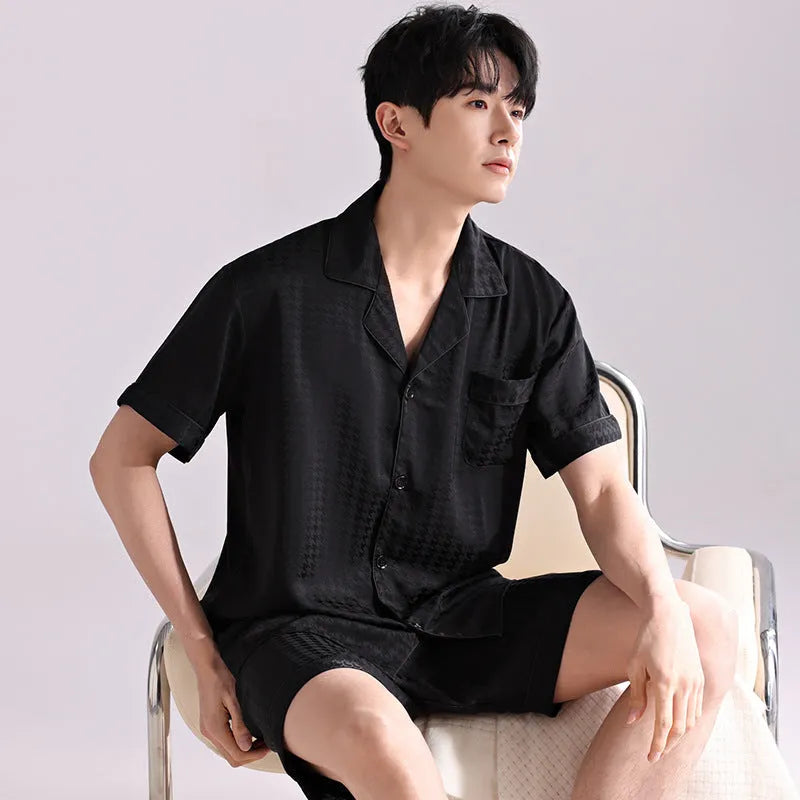 Men's black and white plaid ice silk pajama set with cardigan top and shorts on a hanger.