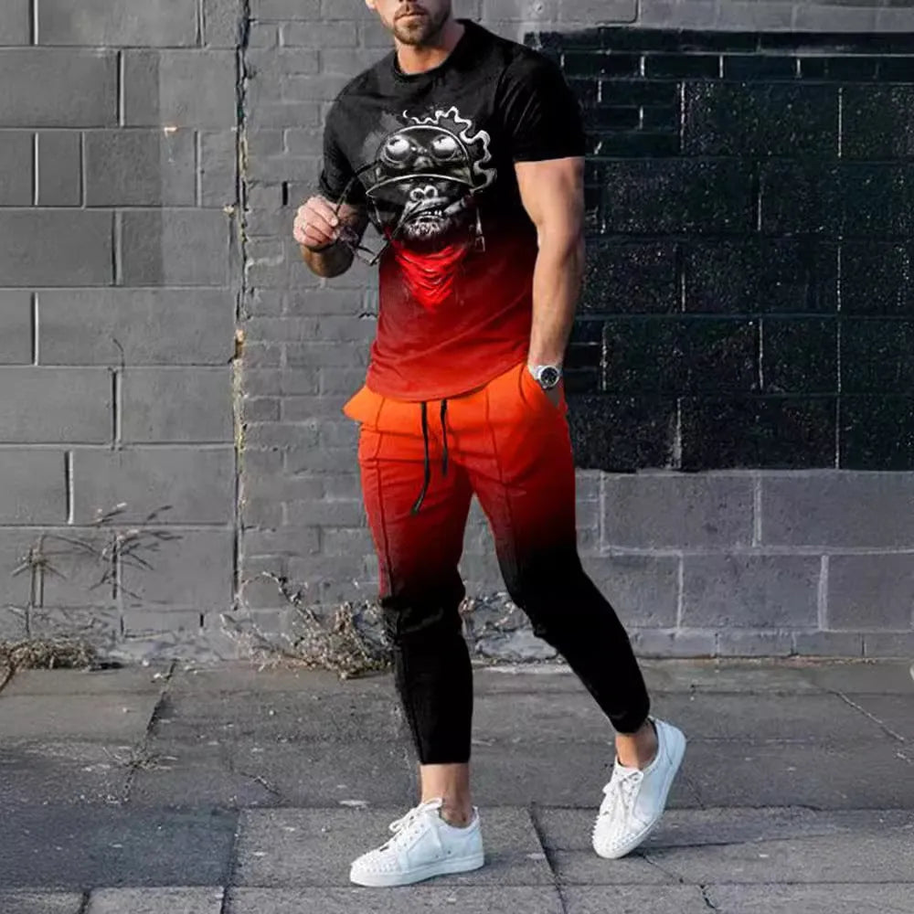 Men's grey printed short-sleeved tracksuit top and trousers laid flat.