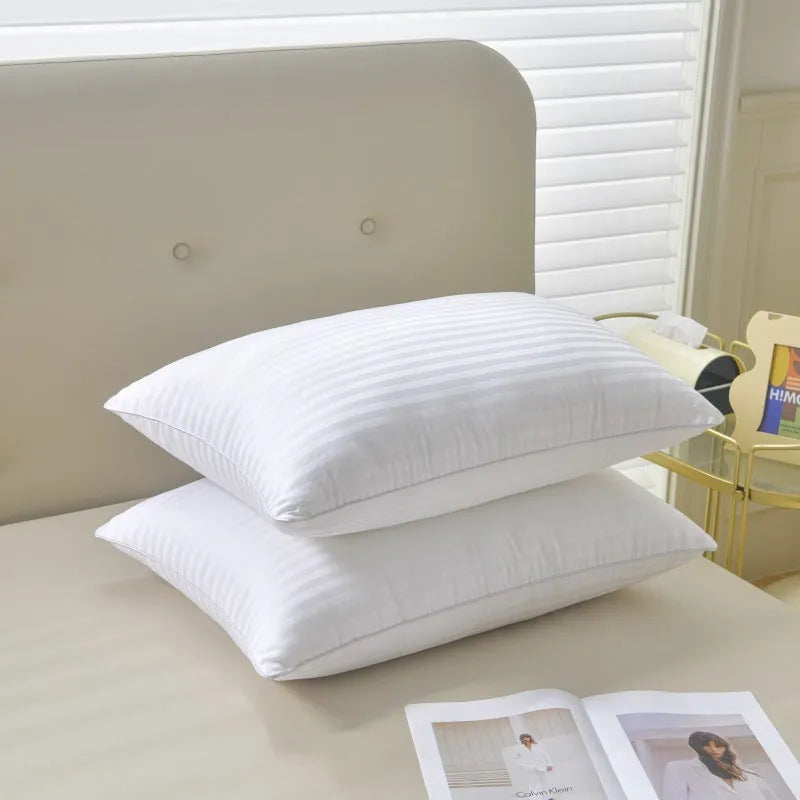 White cotton satin stripe feather and cotton pillow showing three size options