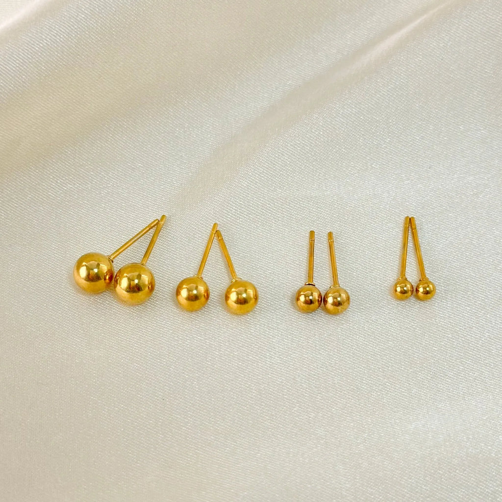 Gold and silver minimalist ball stud earrings in 3mm, 4mm, 5mm, and 6mm sizes on a plain background.