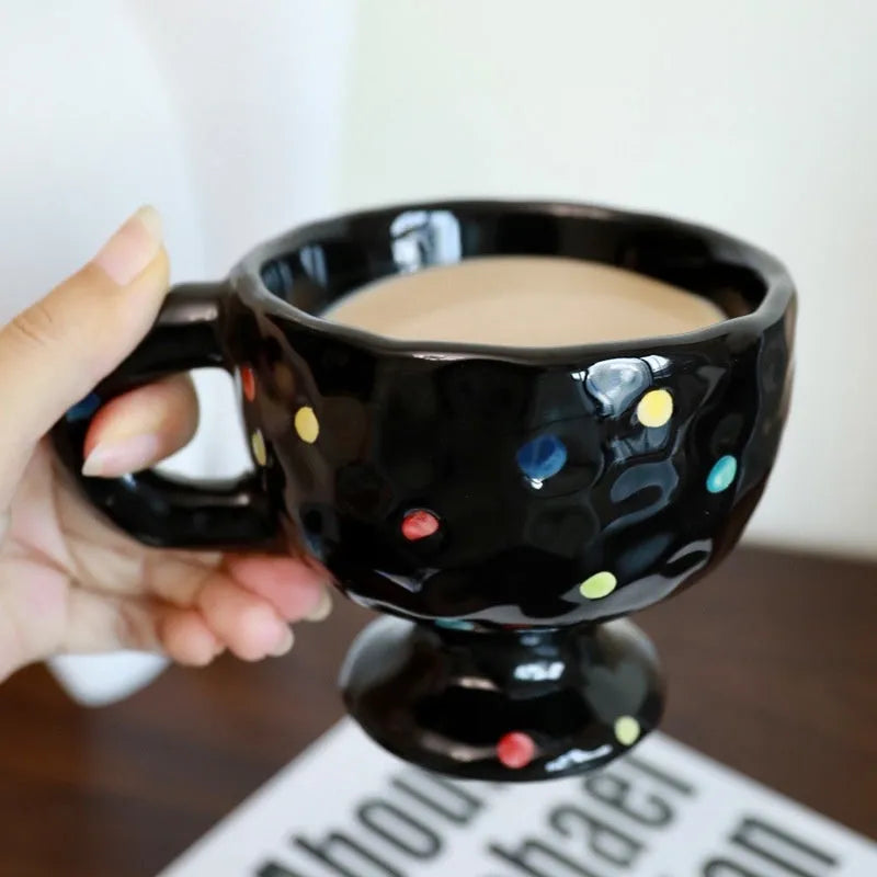 A hand-pinched irregular shaped ceramic mug in a solid colour, shown on a plain background.