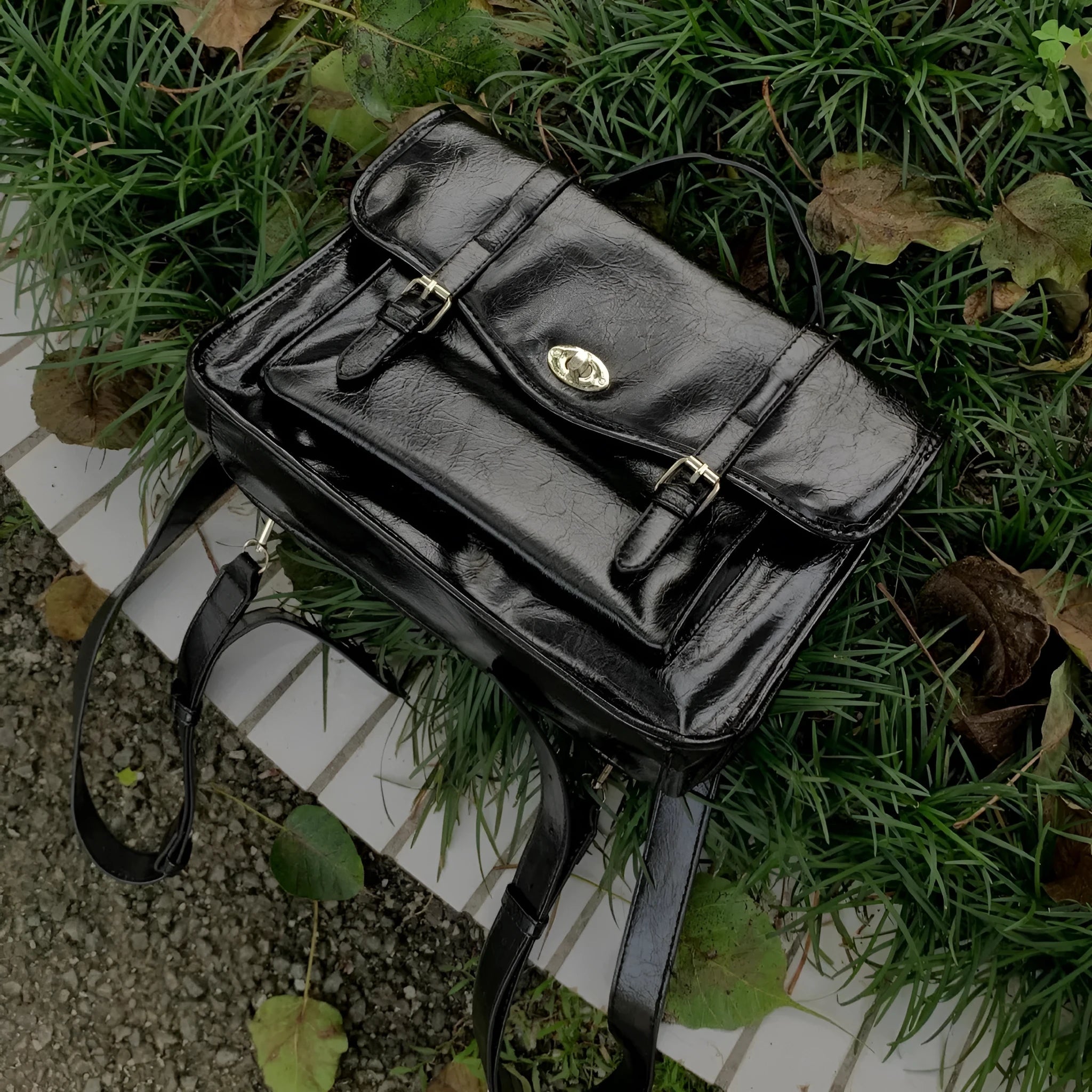 Black college-style messenger bag with oil wax finish and single shoulder strap.