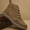Grey genuine leather Martin boots with wedge heel and front lace-up design on a neutral background.