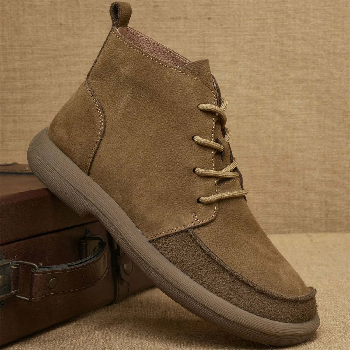 Grey genuine leather Martin boots with wedge heel and front lace-up design on a neutral background.