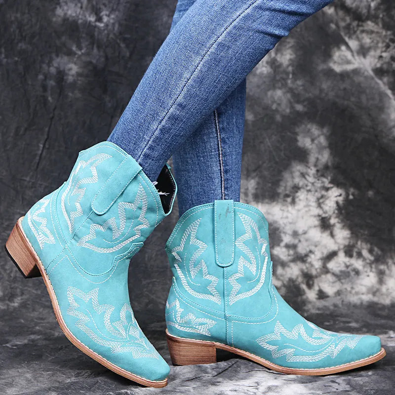 Women's blue embroidered cowboy boots with low chunky heel and pointed toe.