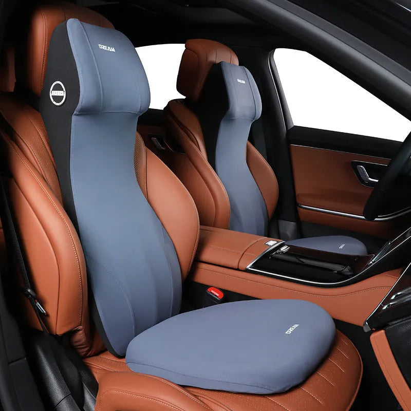 Black automotive memory foam cushion and lumbar support pillow set on a car seat.
