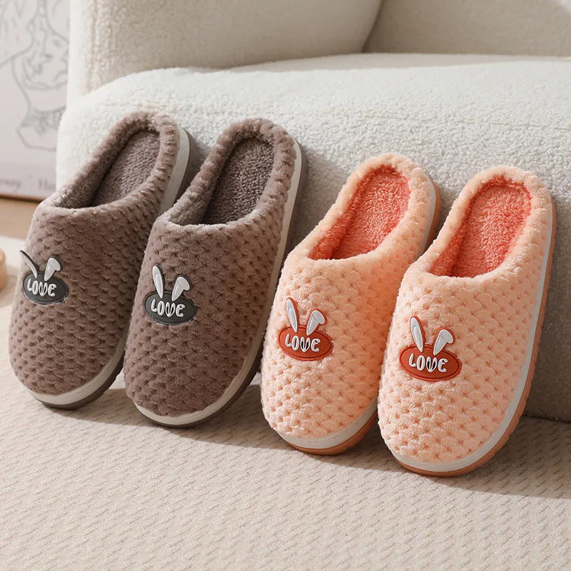 Women's rabbit plaid design artificial fur house slippers with a thick rubber sole.