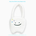 White plush large tooth shoulder tote bag with zip opening shown as crossbody carry