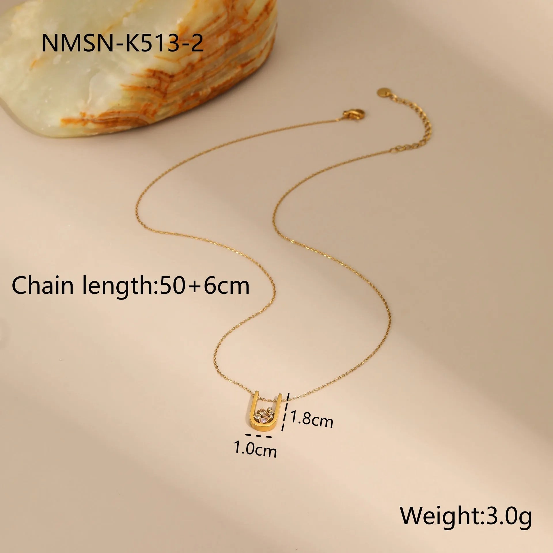 Geometric gold-plated zircon jewellery set showing necklace, ring and earrings with adjustable chain