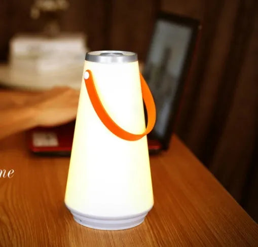 White rechargeable LED table lamp with adjustable warm light settings and USB charging cable