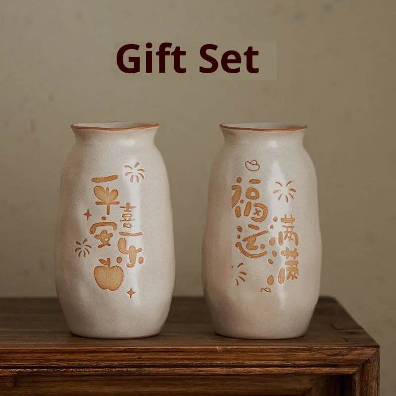 Chinese hand-painted ceramic vase with carved design on wooden desktop