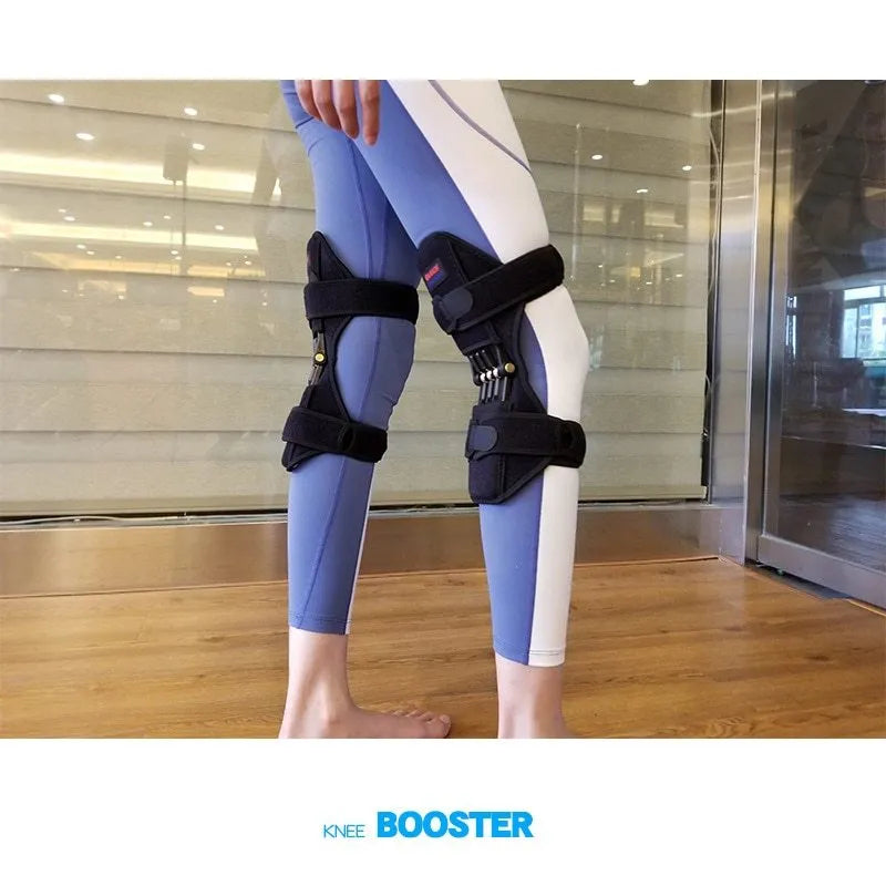 Adjustable spring knee brace in black, shown on a leg, featuring breathable fabric and venting holes for sports support.