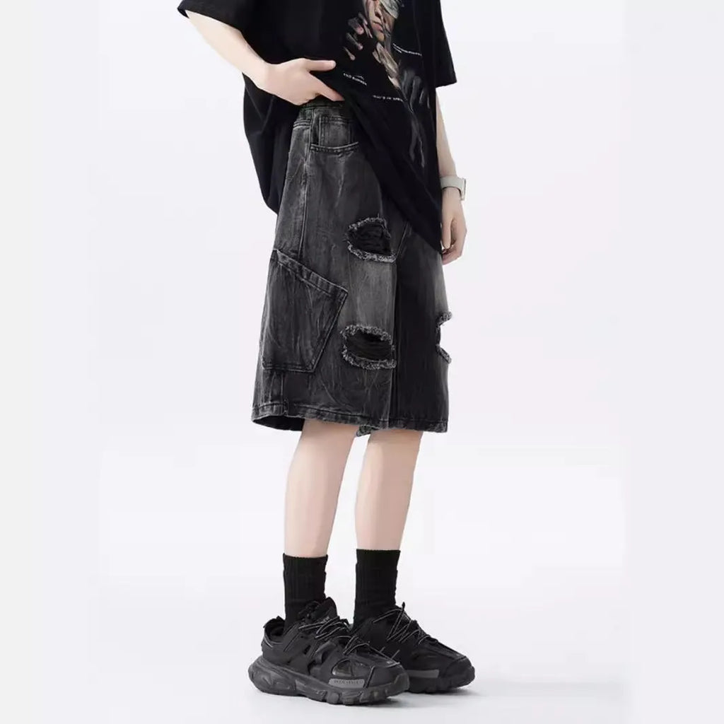 Washed black denim shorts with ripped details and a loose retro fit.