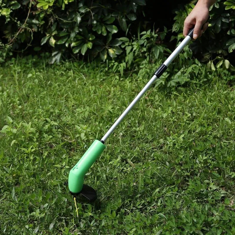 Cordless electric lawn trimmer with extension pole and black debris shield on a green lawn.