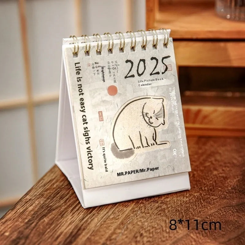 Mini coffee-themed desk calendar showing 2025 dates with motivational text