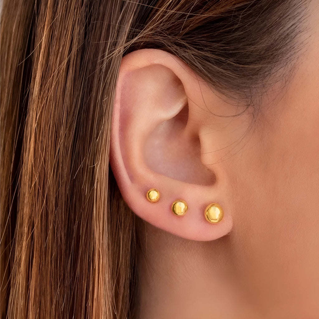Gold and silver minimalist ball stud earrings in 3mm, 4mm, 5mm, and 6mm sizes on a plain background.