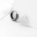 Silver geometric earrings with a retro twist striped pattern, made from titanium steel.