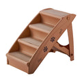 Foldable grey pet stairs with non-slip mats placed next to a sofa for dog or cat use