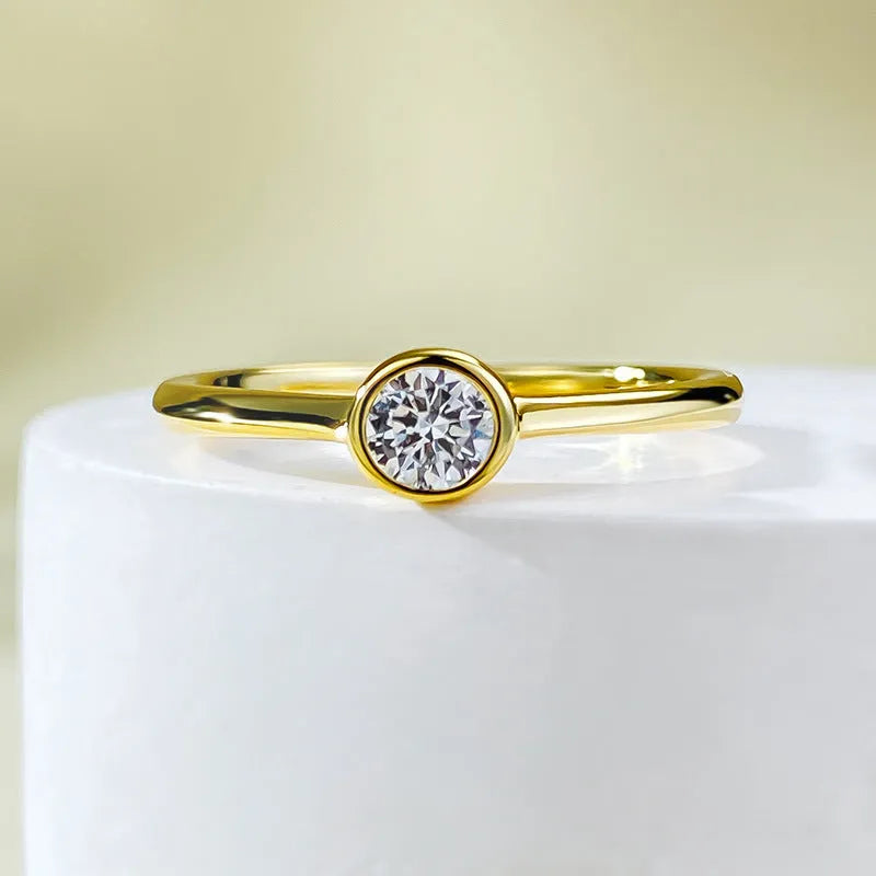Minimalist crown shape silver ring electroplated in gold or platinum colour on a plain background.