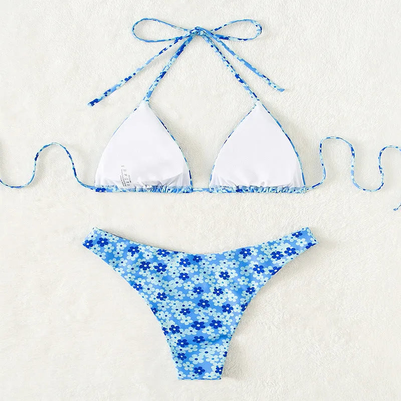 Women's blue printed two-piece swimsuit with lace-up front on ruffled shorts and sleeveless top.
