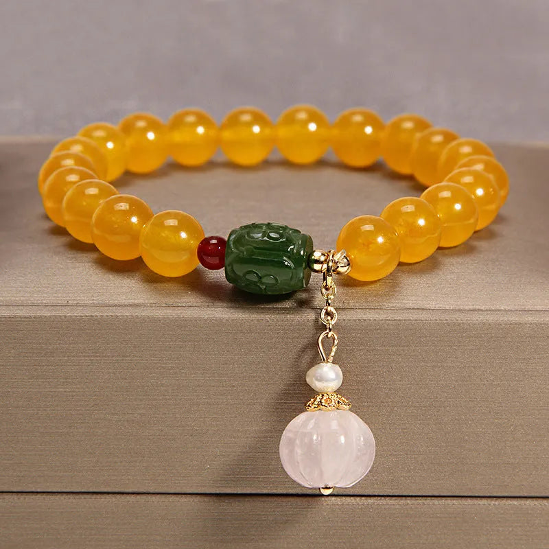 Women's yellow agate crystal beaded bracelet with gold silk thread and tassel.