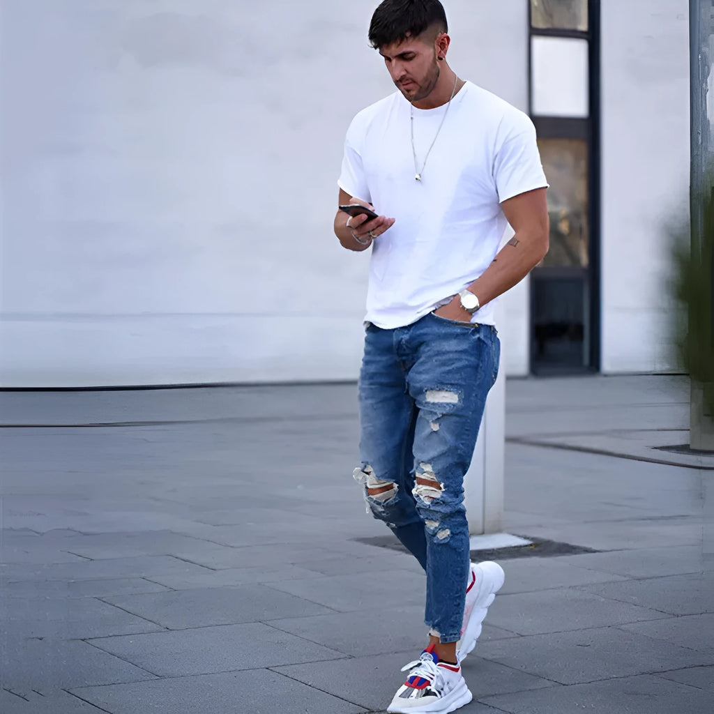 Deep blue hole jeans for men made from 100% cotton fabric showing classic denim styling