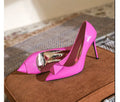 Women's pink patent leather stiletto heels with pointed toe and buckle fastening on rubber sole