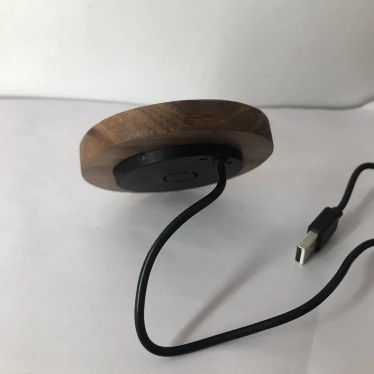 Round embedded wireless phone charger for installation in desks and furniture, shown with USB port.