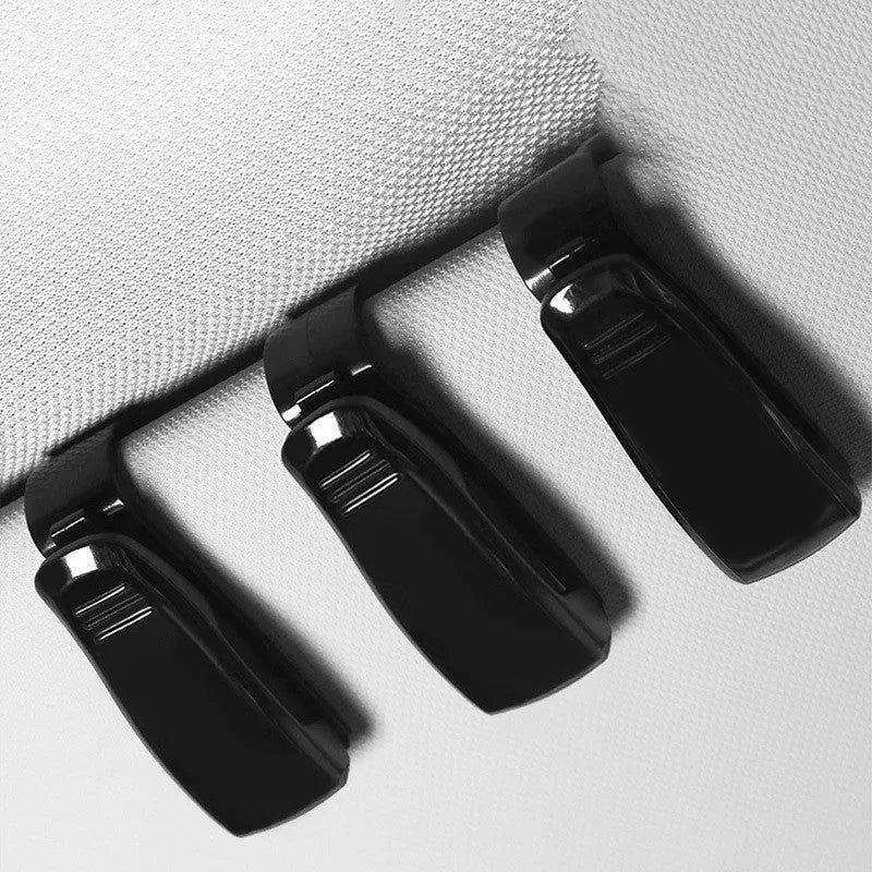 Black plastic car sunshade clip for holding glasses, tickets and ID cards, dimensions 6.5 by 2.3 centimetres