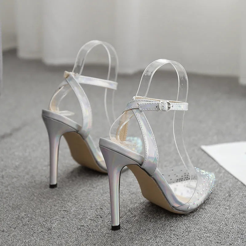 Women's pointed toe stiletto sandals with diamond ornamentation on a PVC upper.