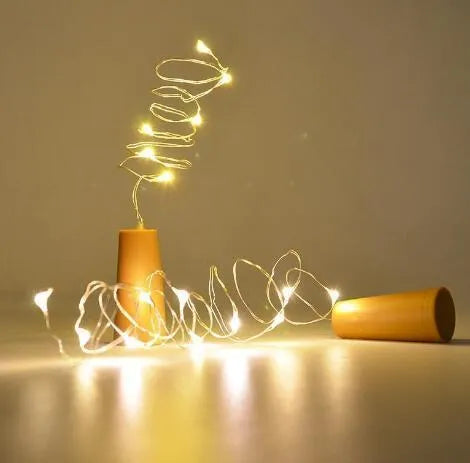Copper wire LED string light with 20 bulbs inserted into a wine bottle for decorative lighting