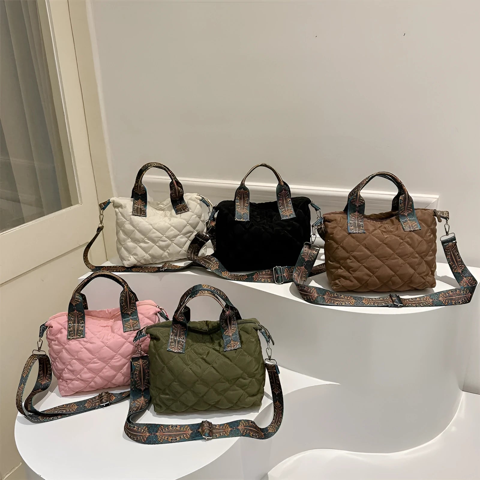 Simple shoulder messenger bag in Oxford cloth shown in multiple colours with embroidery detail and outer sandwich pocket.