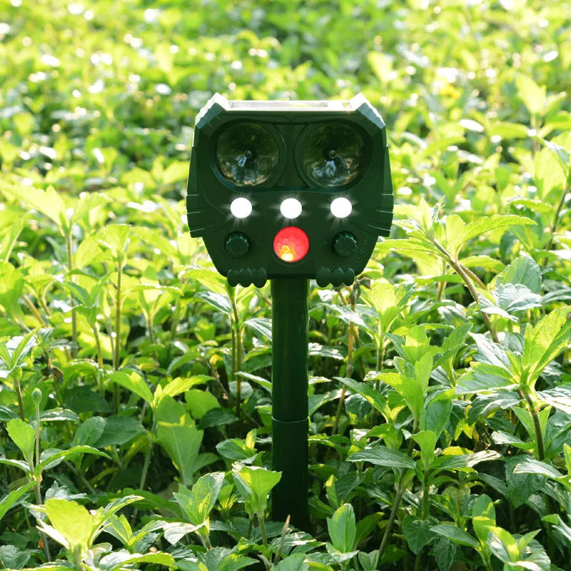 Green solar-powered ultrasonic animal repeller with motion sensor for outdoor pest control.