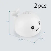 Electric whale bath toy spraying water with flashing LED lights in baby bath