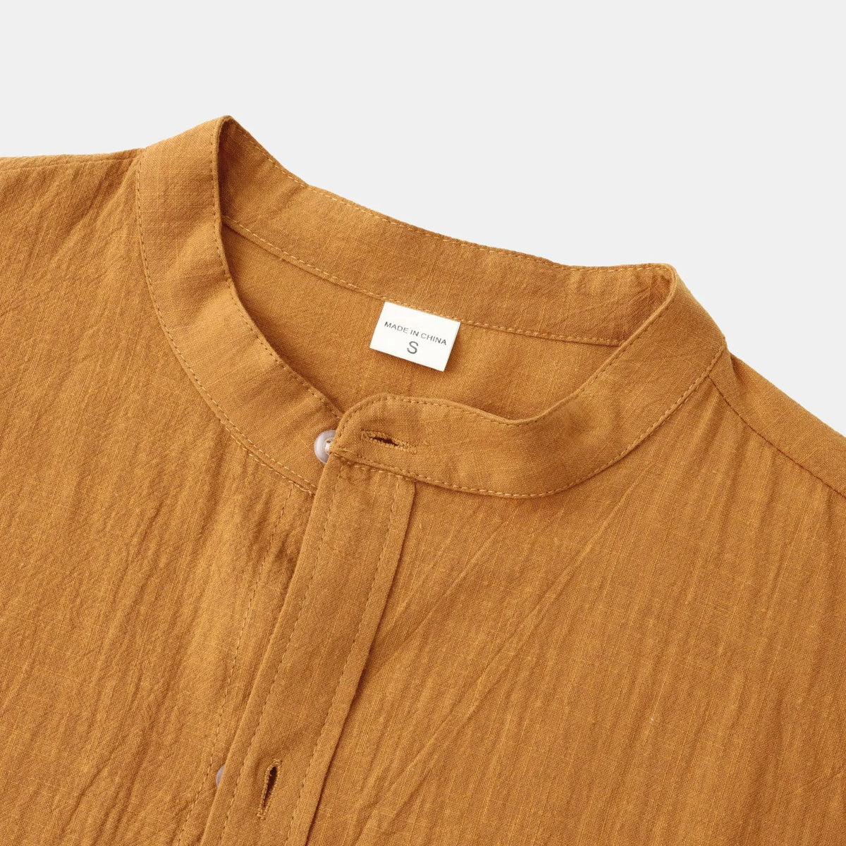 Men's slim-fit brown cotton blend long sleeve shirt and matching casual trousers laid flat.