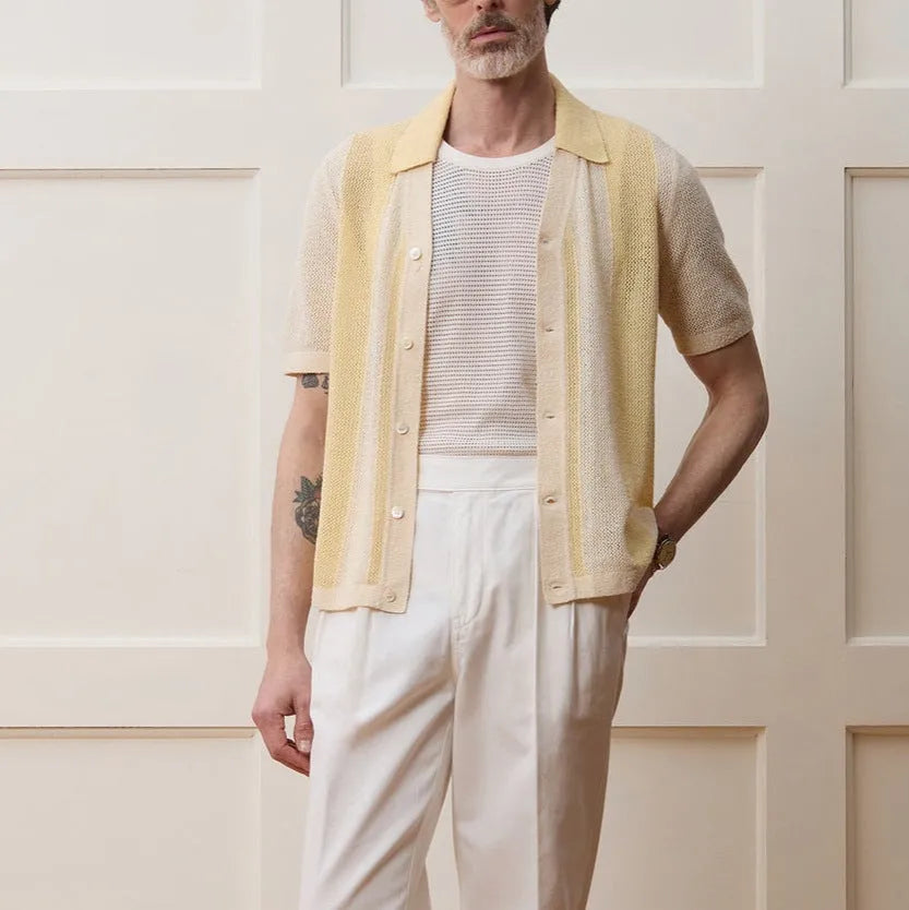 Yellow asymmetric casual polo shirt with hollow-out detail and short sleeves, made from Tencel fabric.