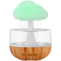 White cloud-shaped humidifier with LED night light on a table