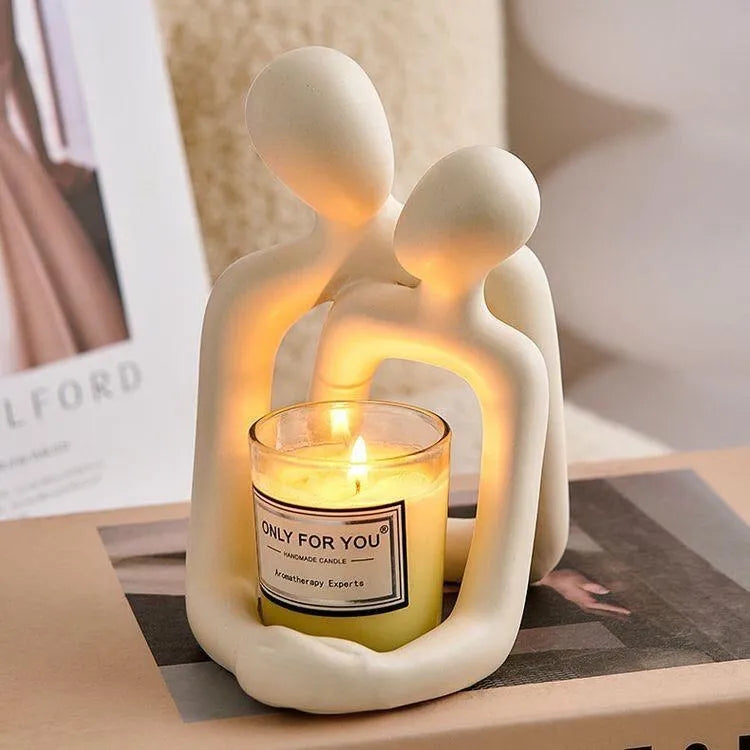 Modern milky white loving couple resin statue displayed on a wooden desk