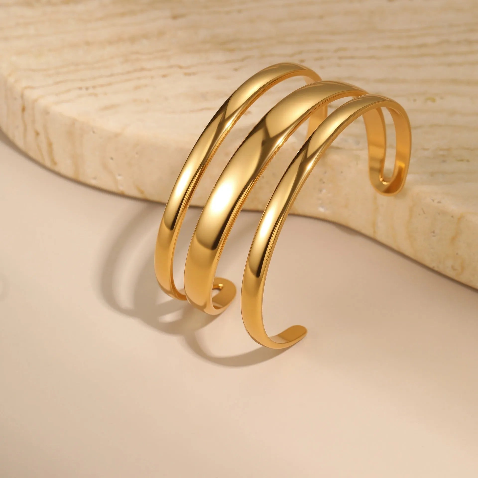 Gold electroplated stainless steel geometric line bracelet for women with a simple clasp.